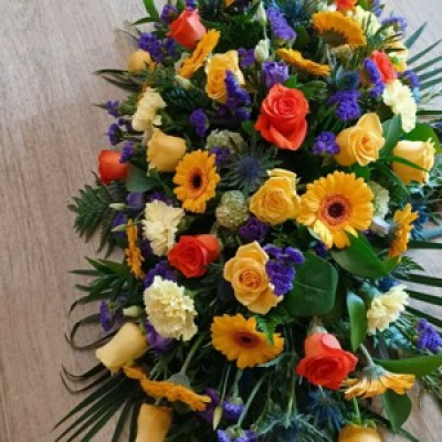 Bright Coffin spray - Orange, yellow, purples and vibrant flowers. This coffin spray can be made up in 3ft, 4ft and 5ft sizes.